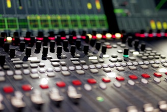 Mixing console with lights and knobs.