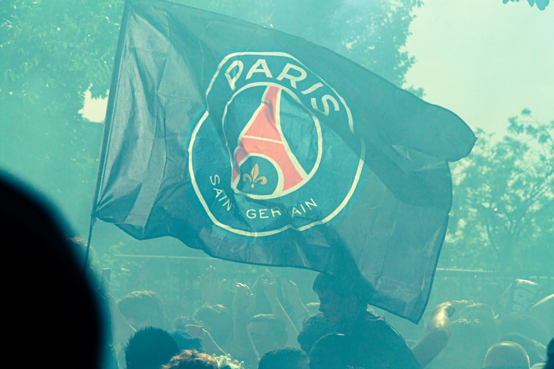 A paris saint-germain flag waves in the crowd.