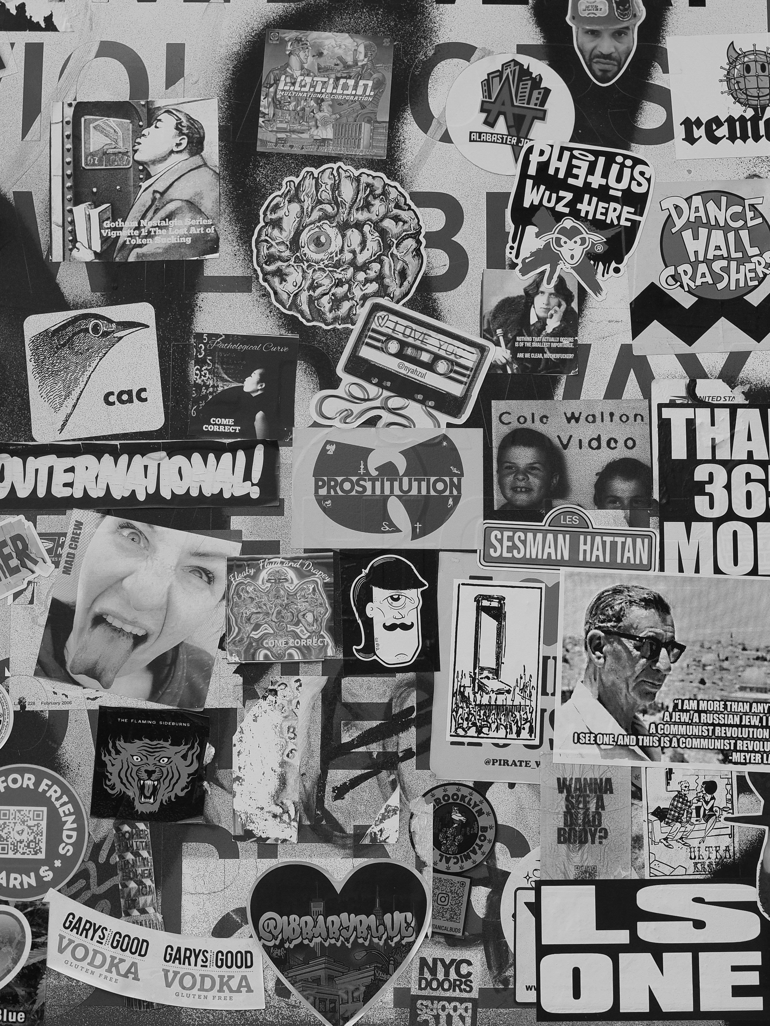 A collage of various stickers and posters on a wall.