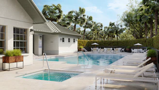 A pool area with loungers and palm trees.