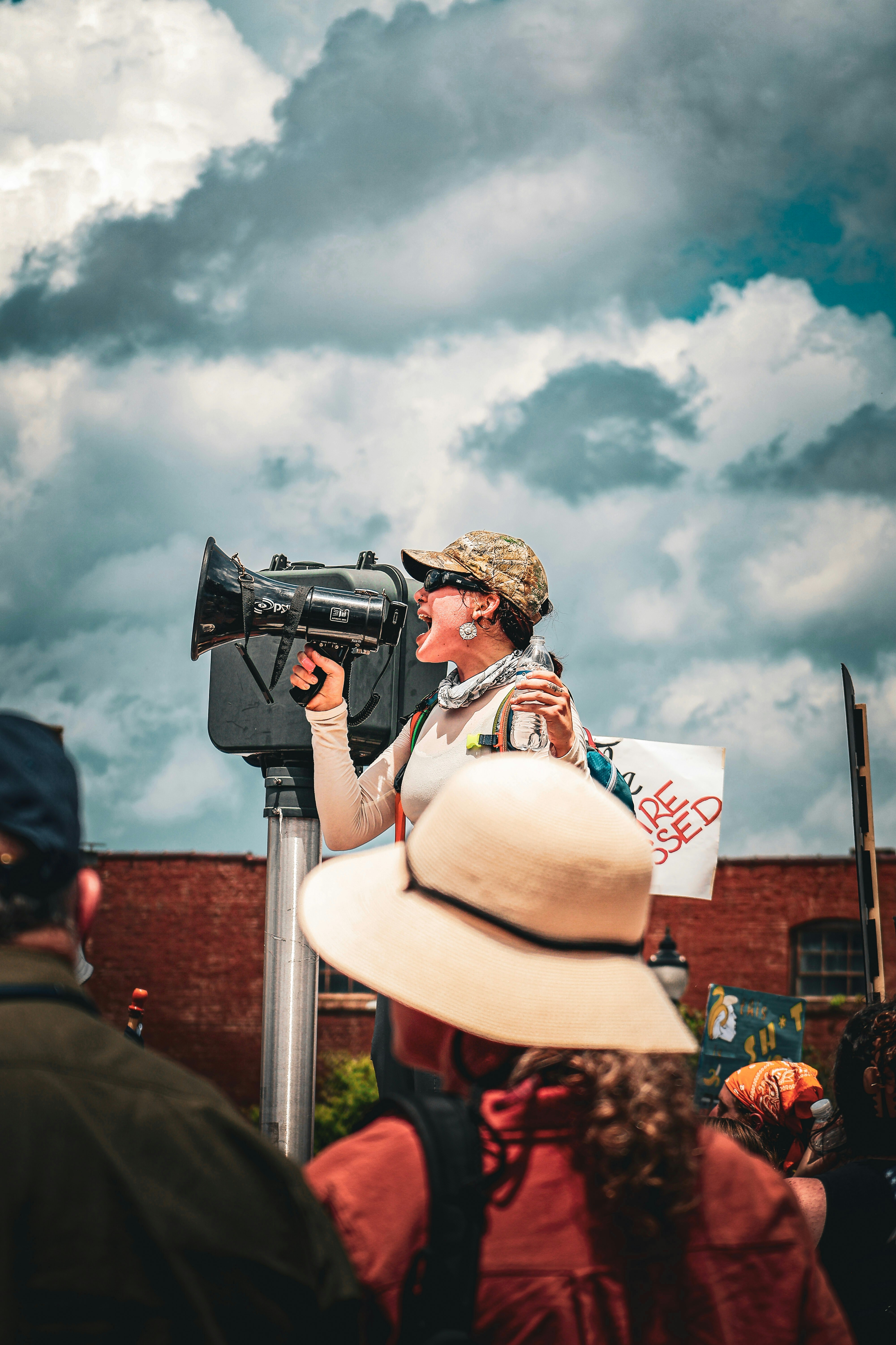 A protester speaks into a megaphone at a rally.