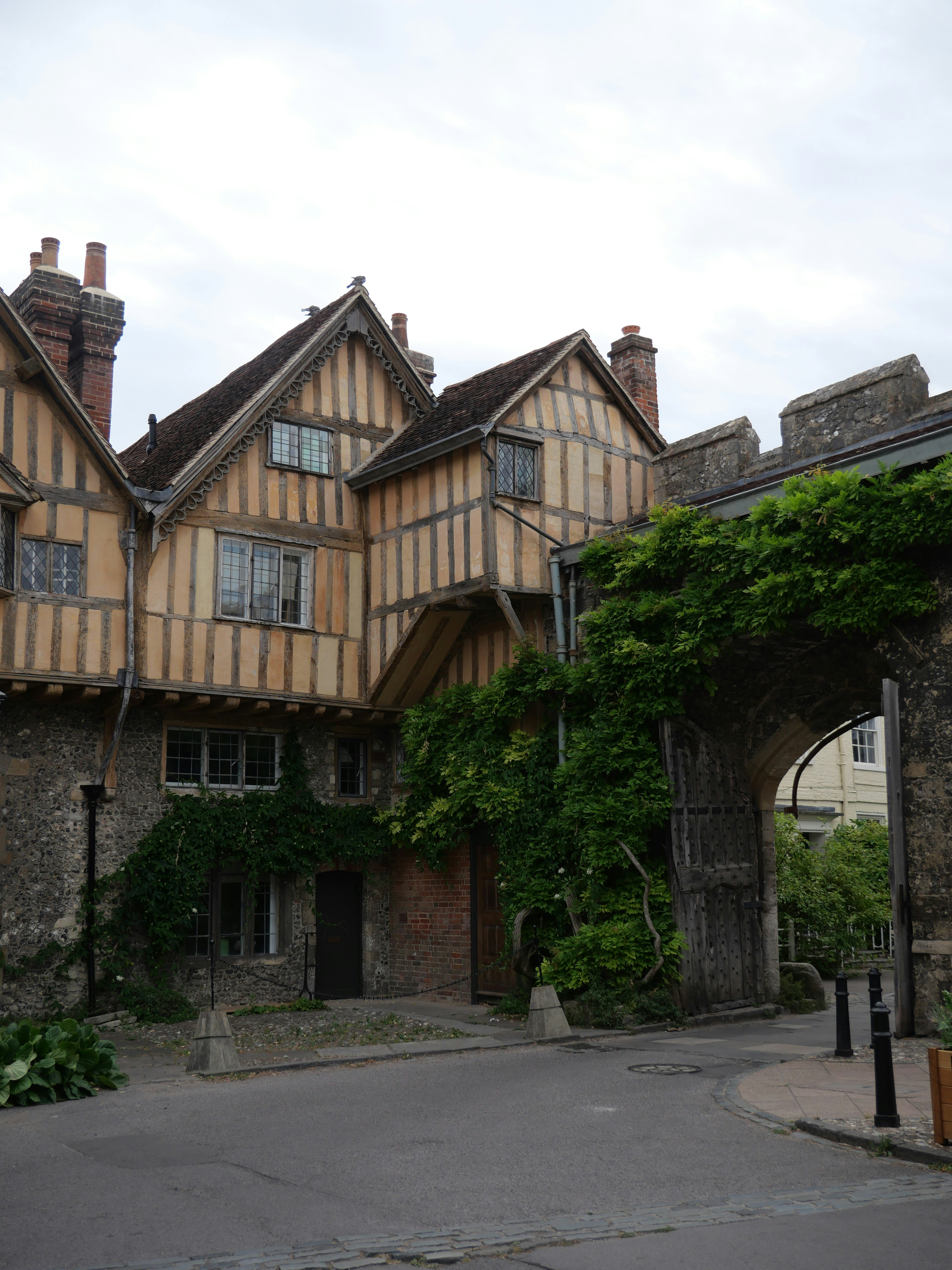 A historic building with vine-covered archway.