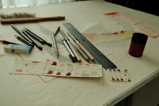 Drawing and painting supplies are arranged on a table.