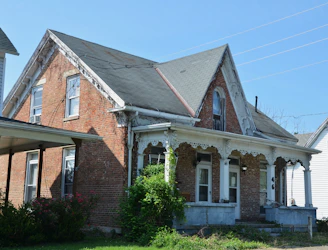 Old brick house with a covered porch