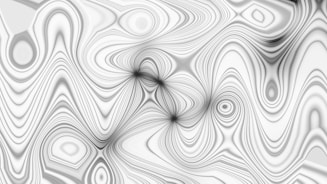 Abstract gray and white swirling patterns form a design.
