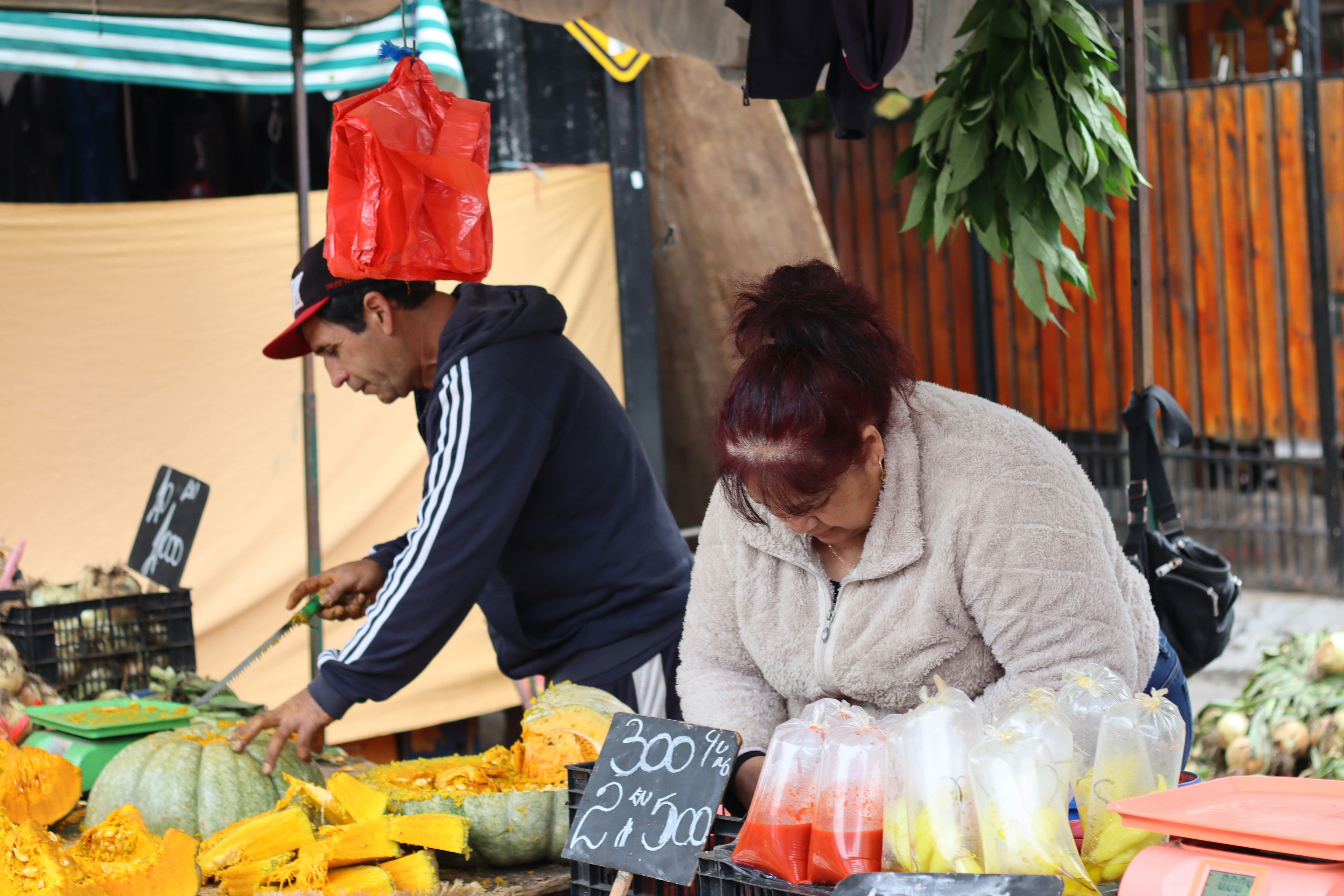 People working at a produce market.