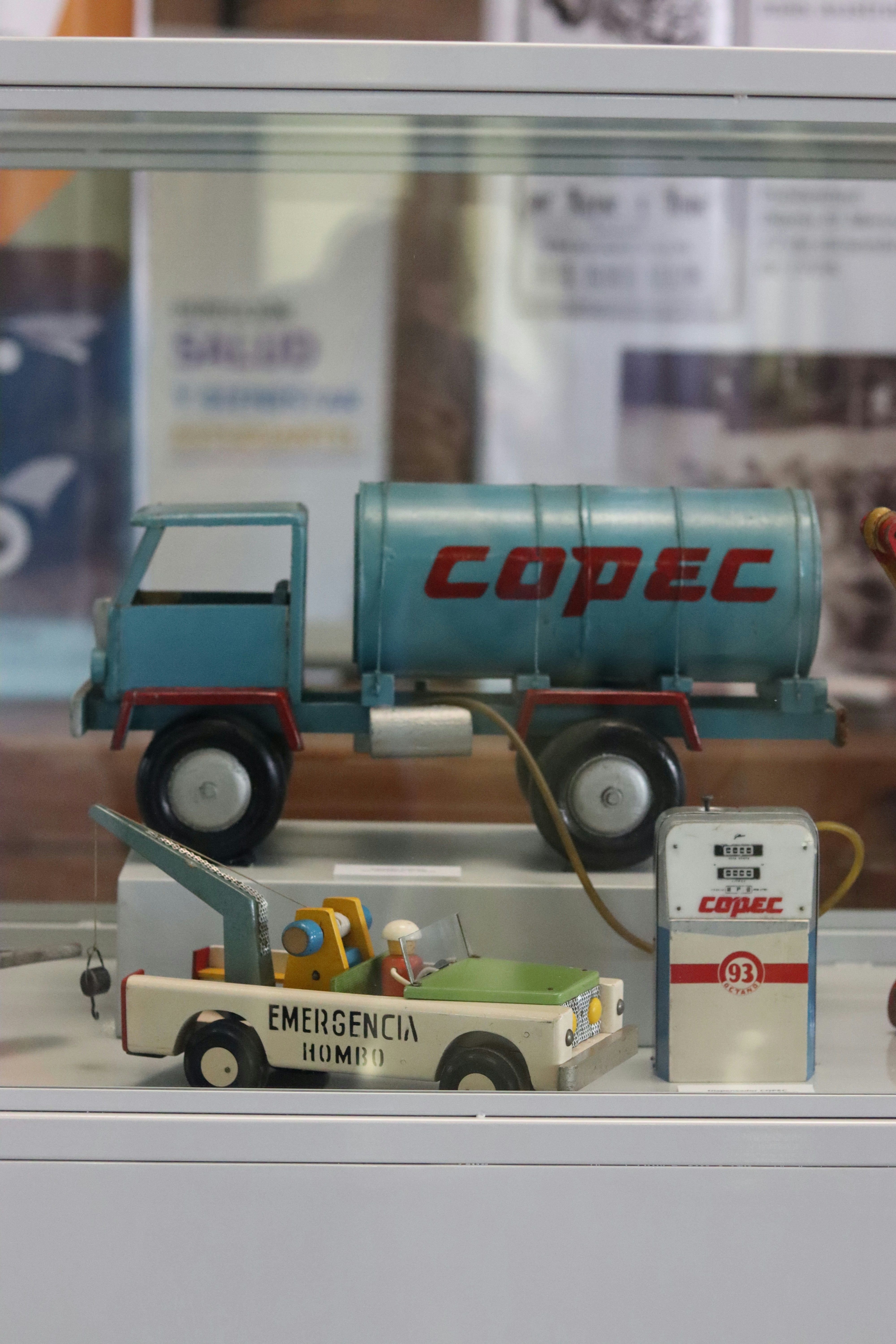 Vintage copec toys are displayed in a glass case.