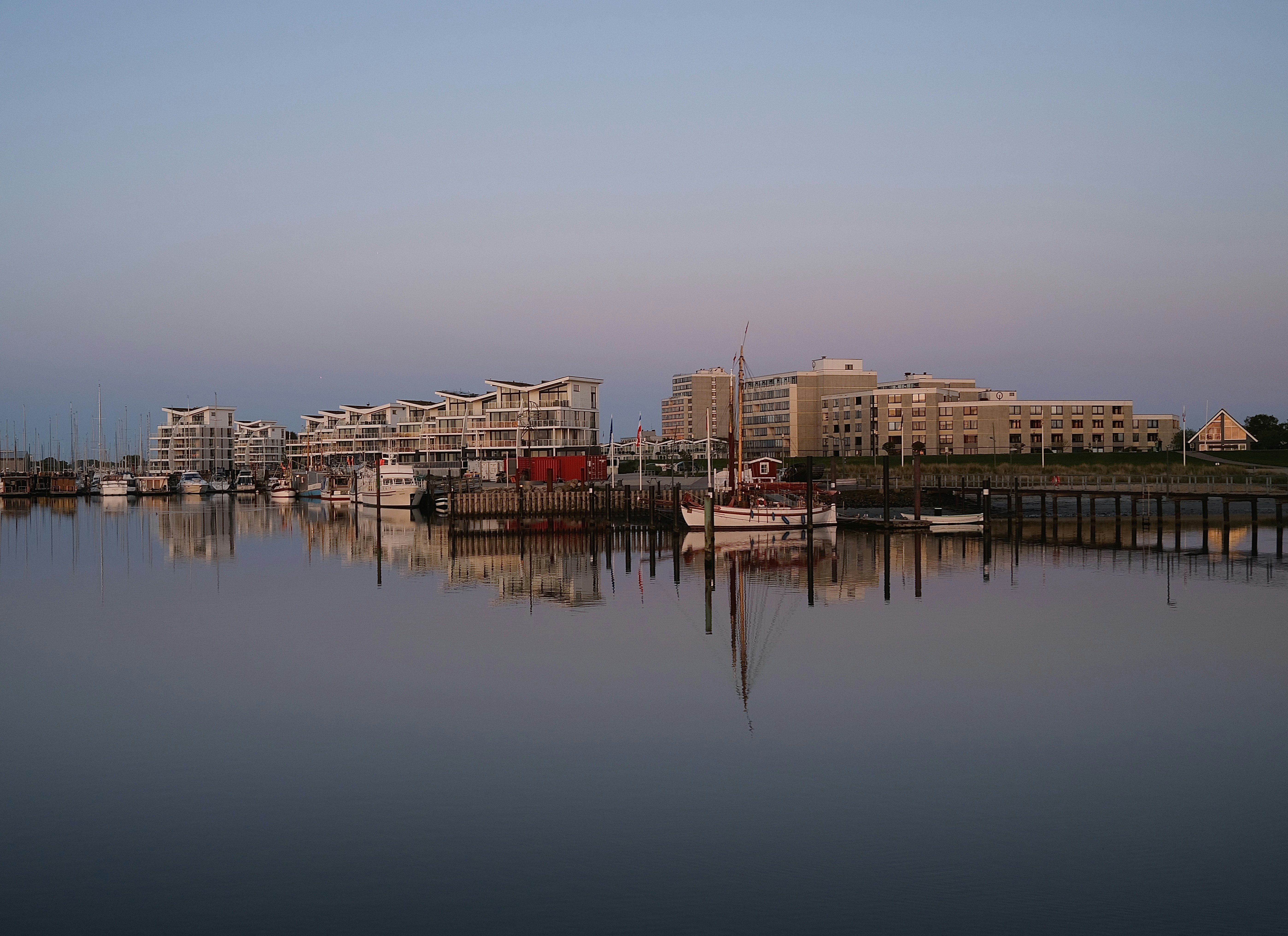 Boats docked in a harbor at dusk.