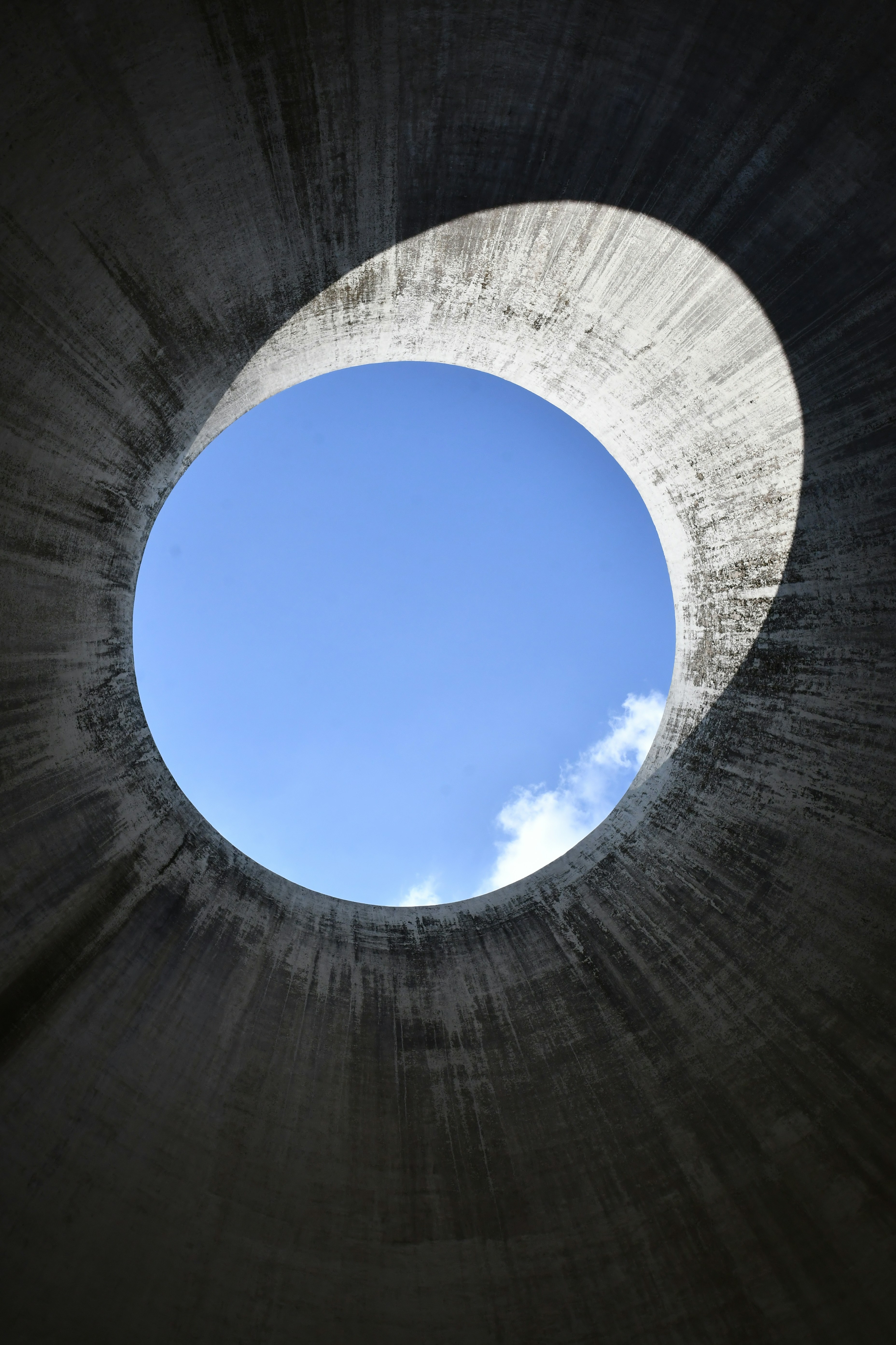 Looking up through a concrete tunnel.
