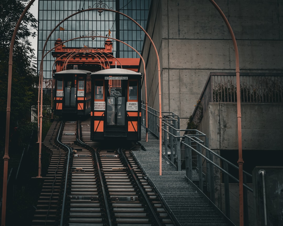 Two cable cars are ascending on tracks.,
