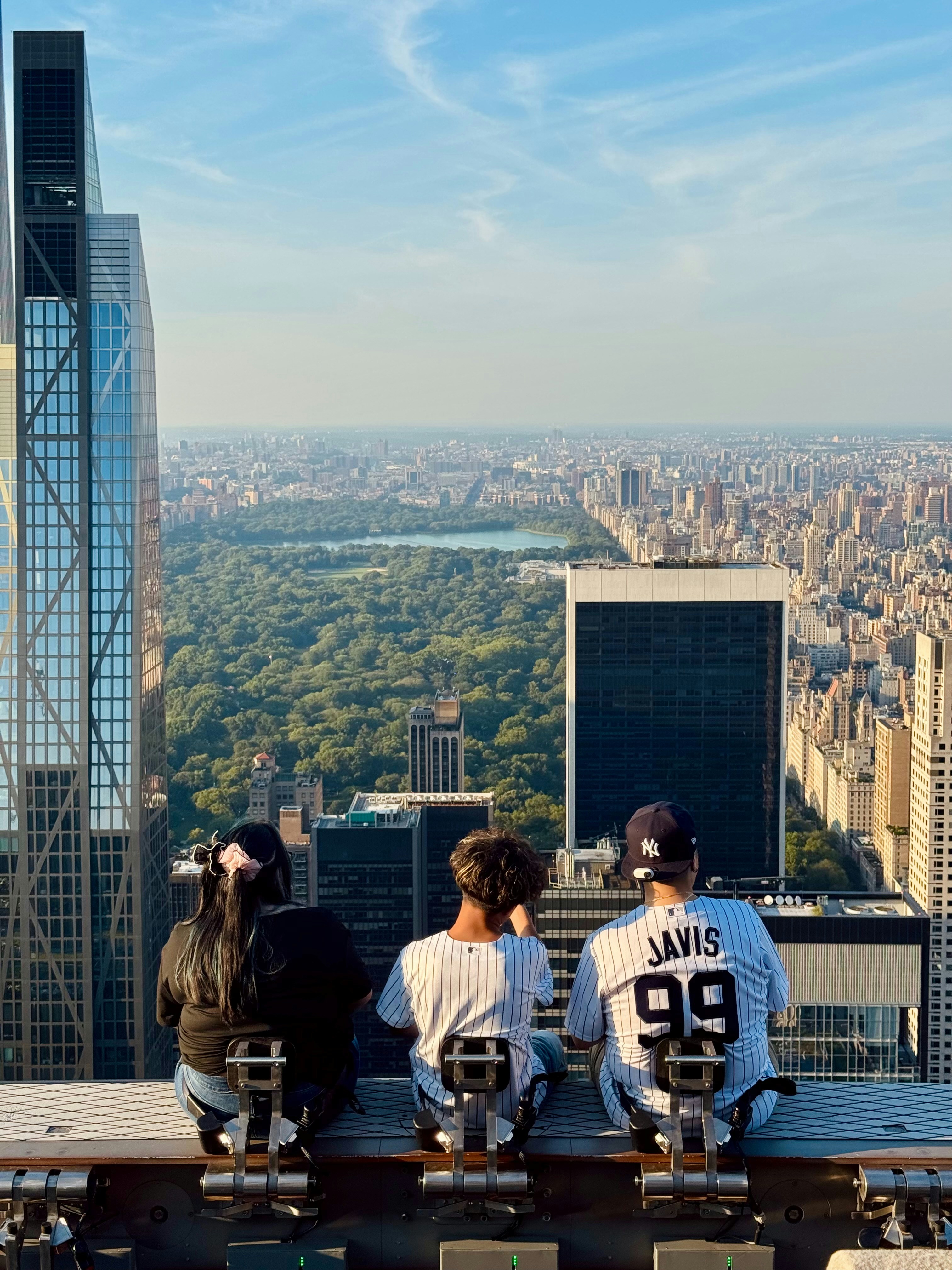 Three people enjoy a skyline view in new york city.