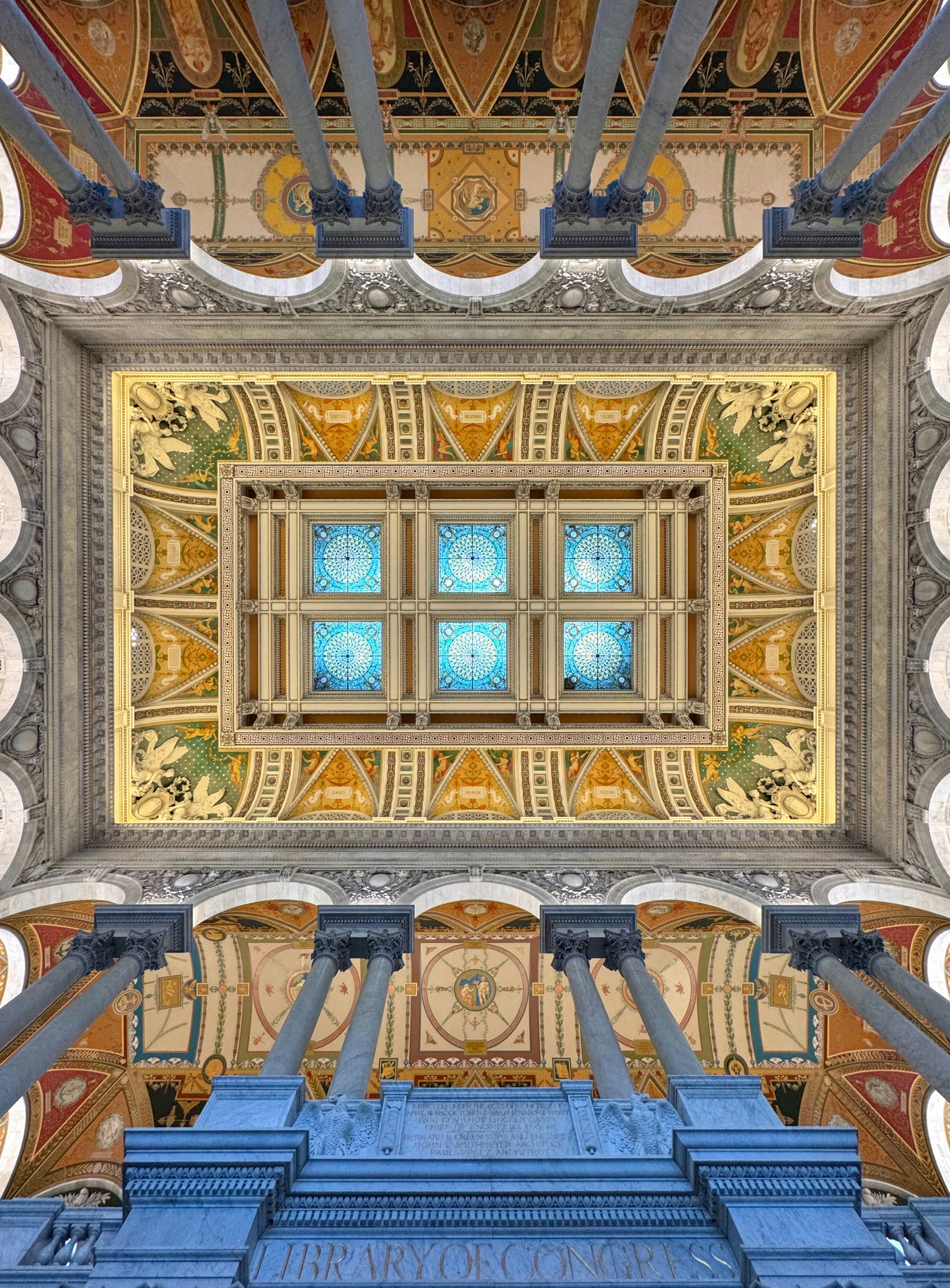 The library of congress's ornate ceiling is viewed from below.