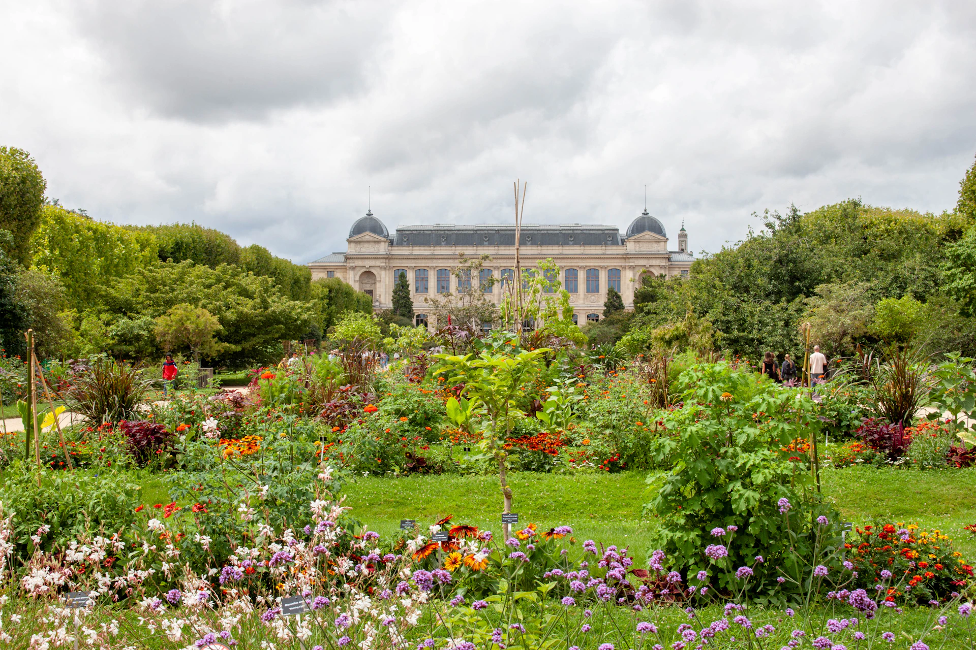 A beautiful garden with a building in the distance