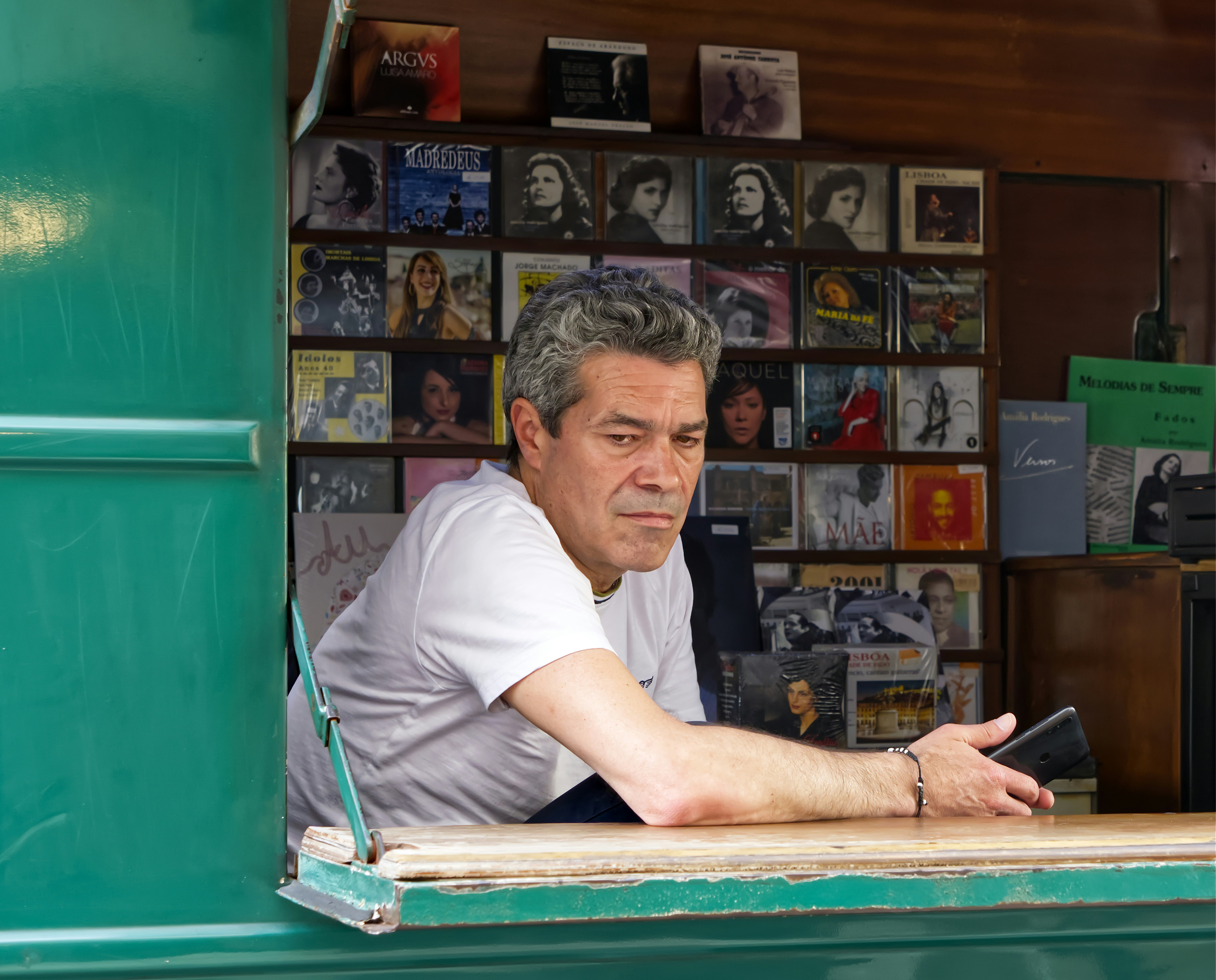 Man at record store looks pensive.