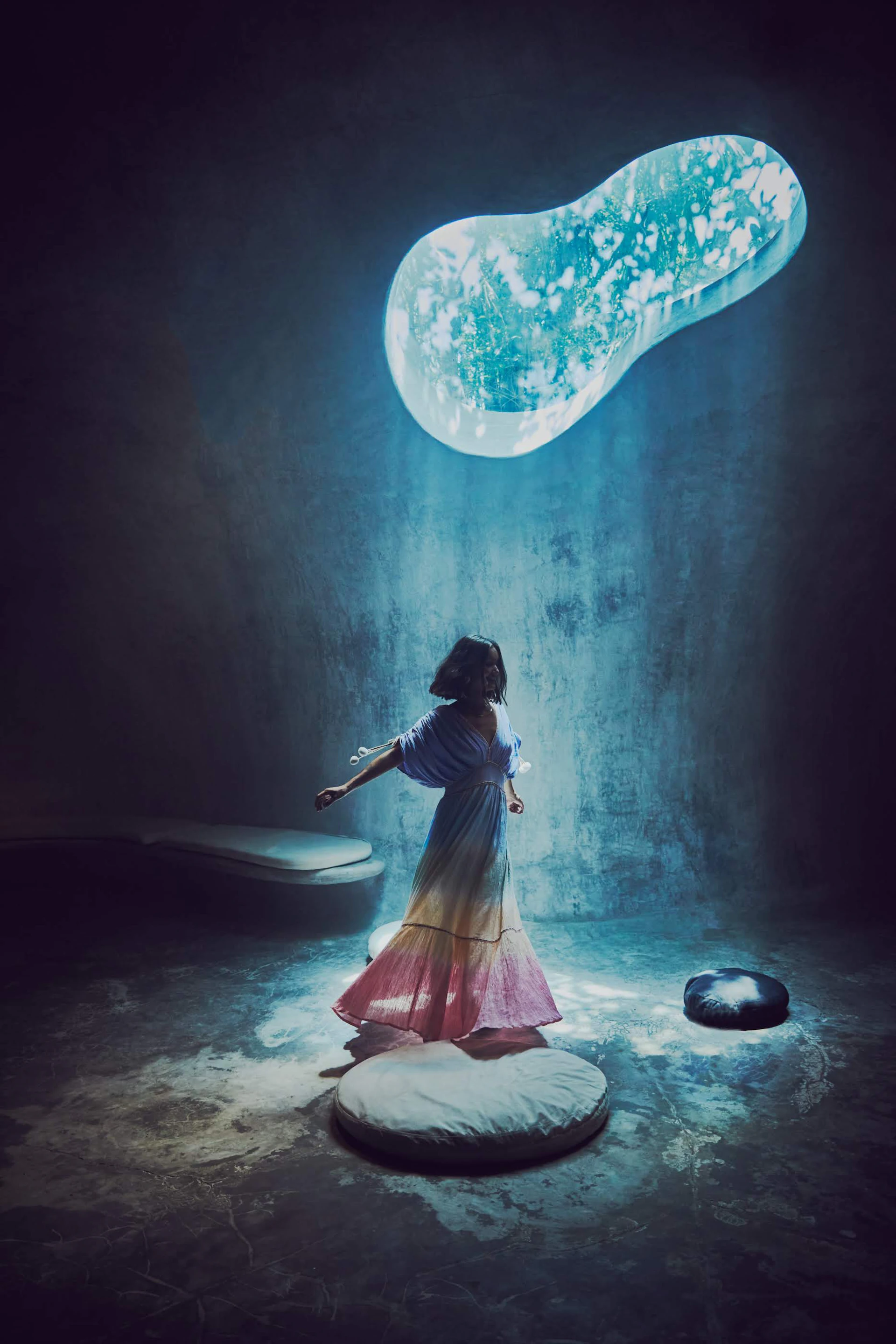 A woman stands beneath a glowing orb.