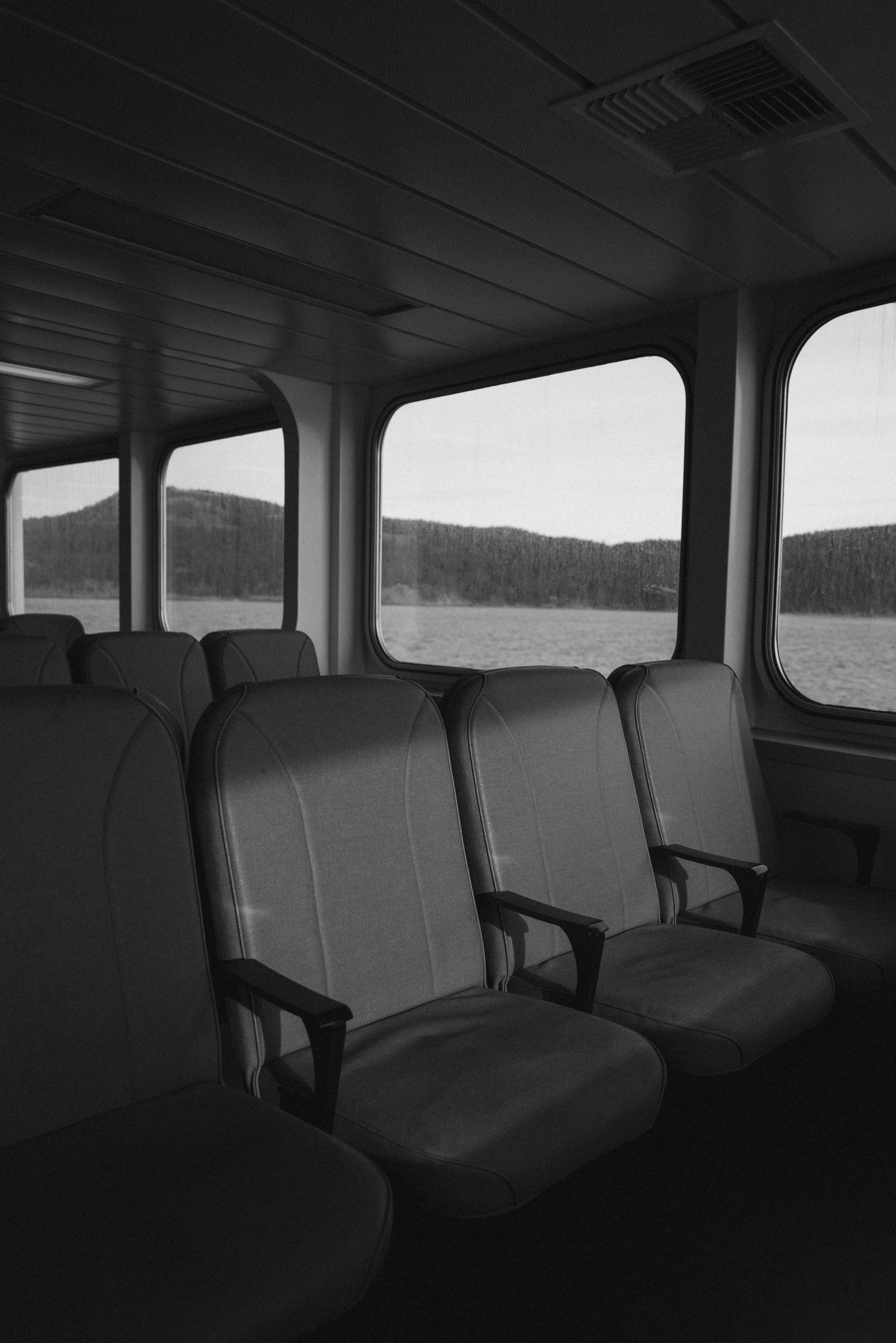 Empty ferry seats with a scenic view.