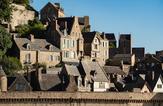 Old stone buildings are seen on a hill.