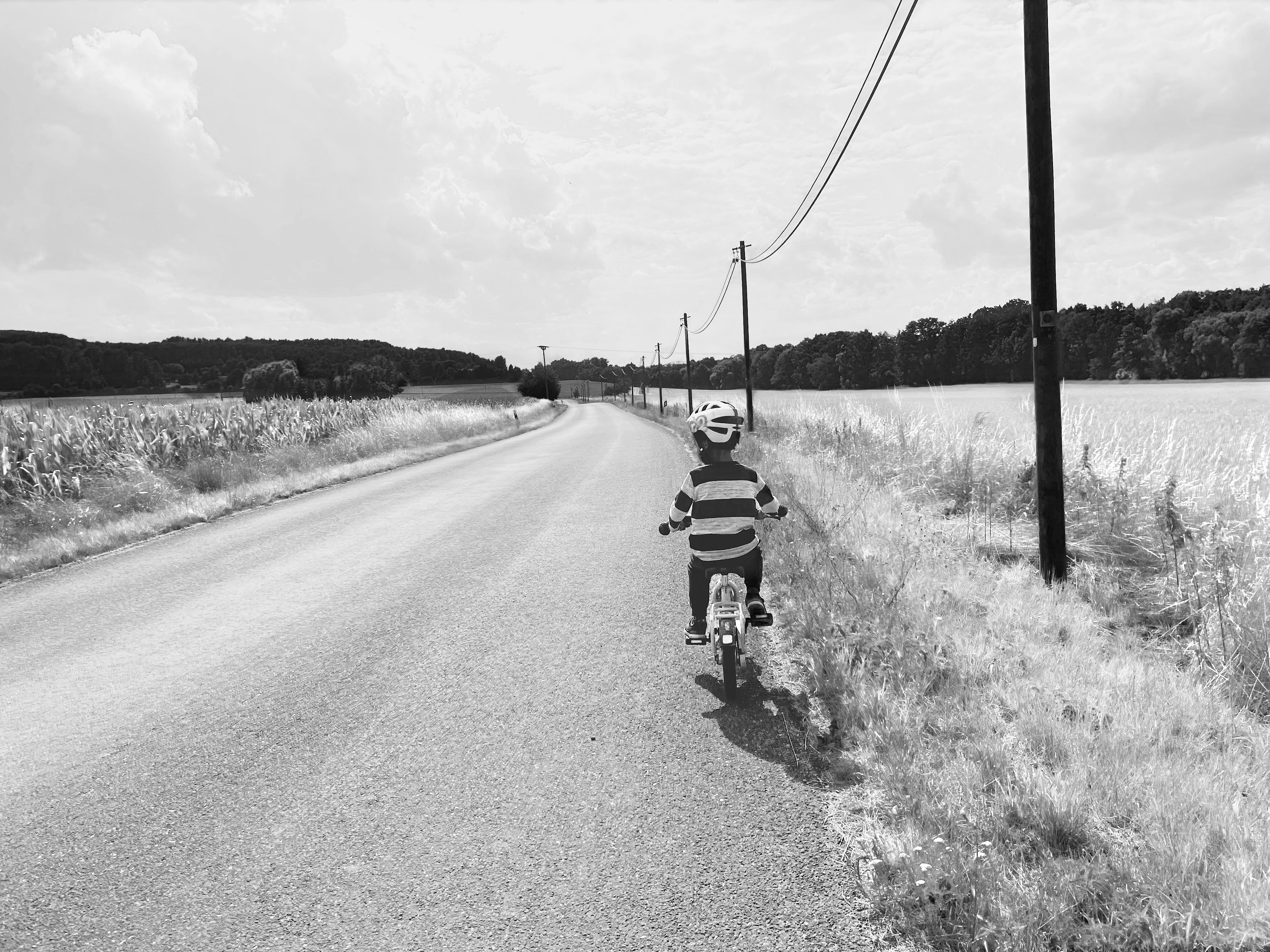 A person rides a scooter down a road.