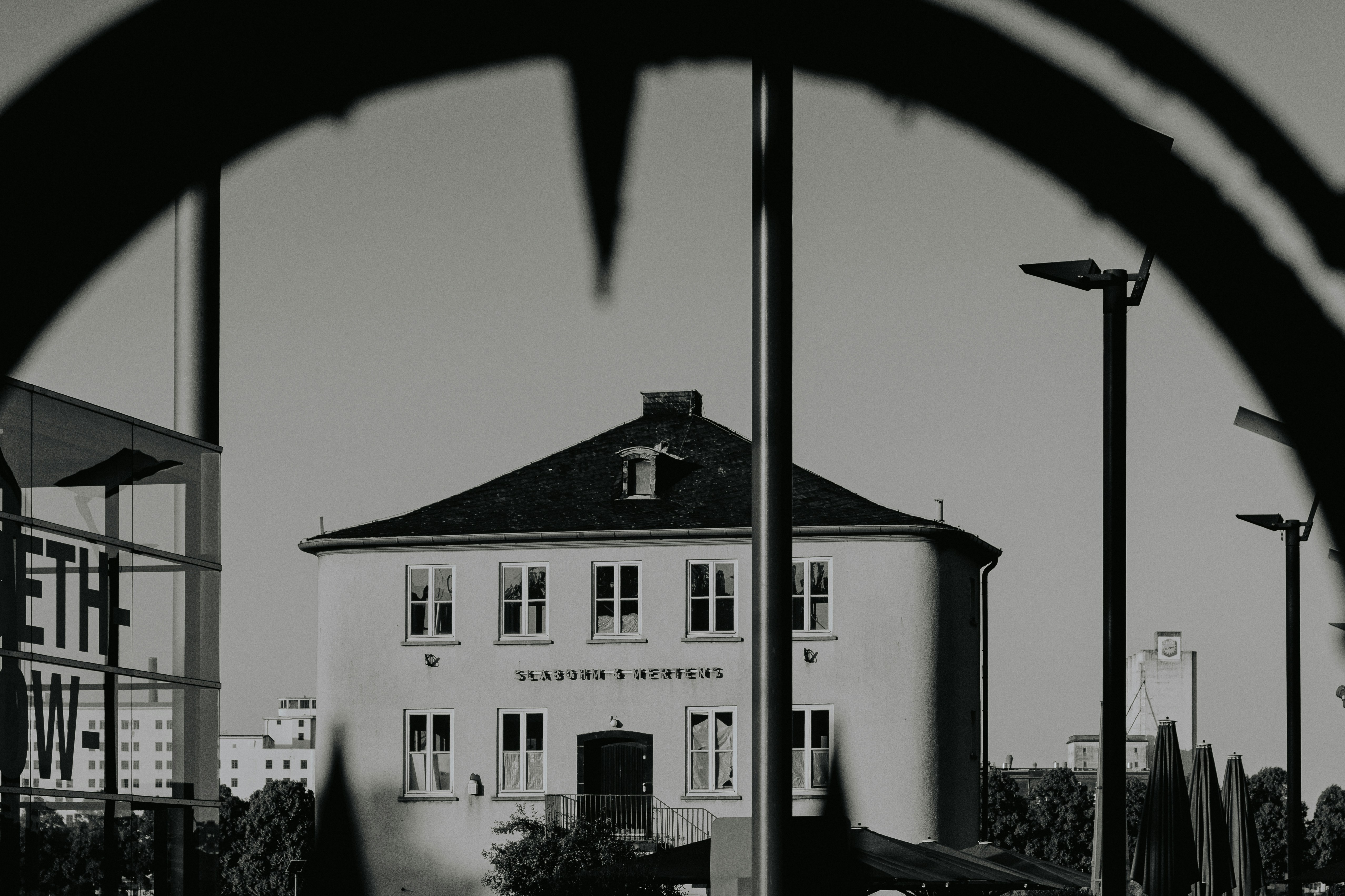 A building is seen through a fence.