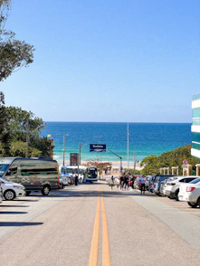 Road leads to the beach on a sunny day.