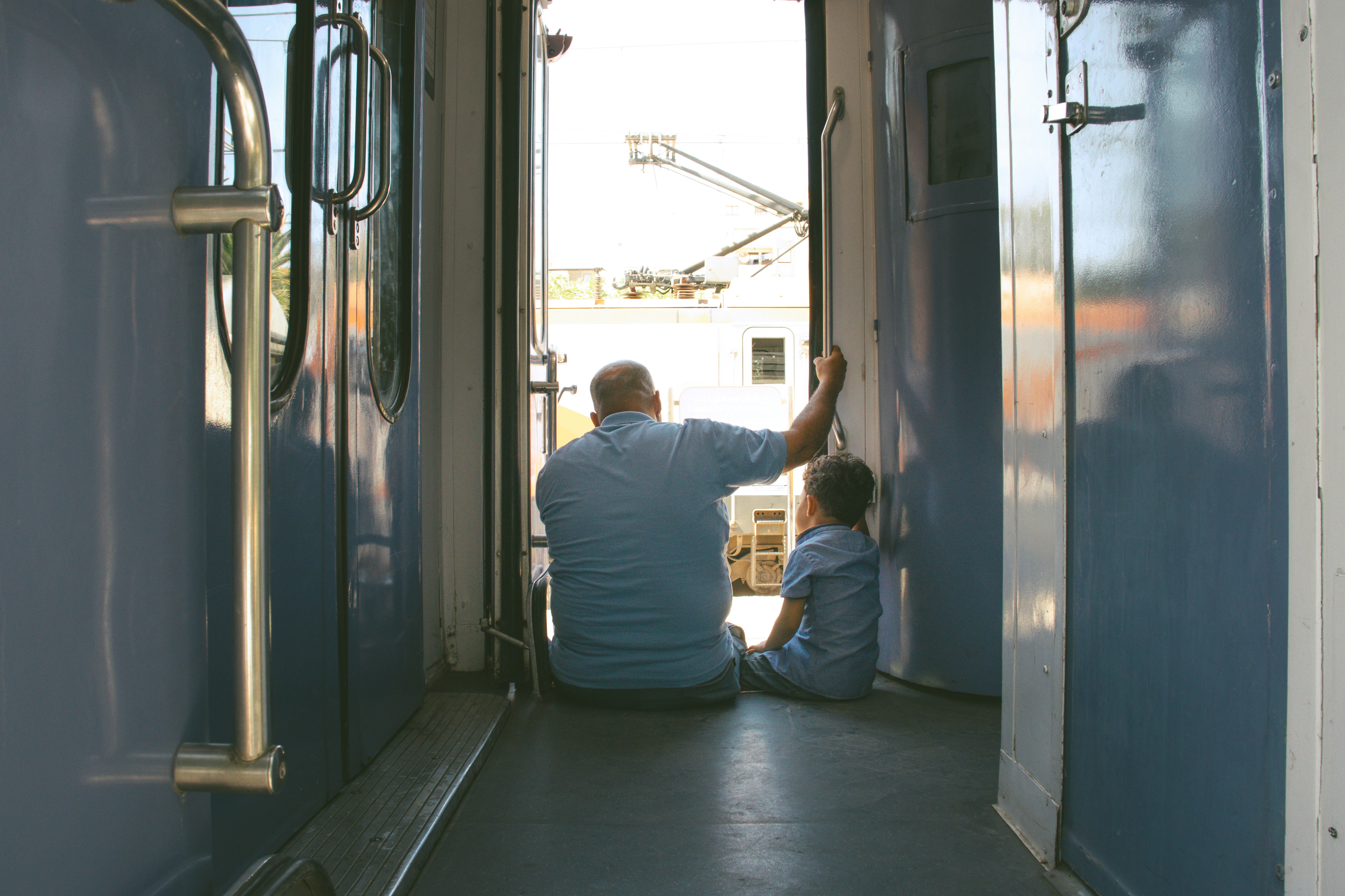A man and child sit, looking out.