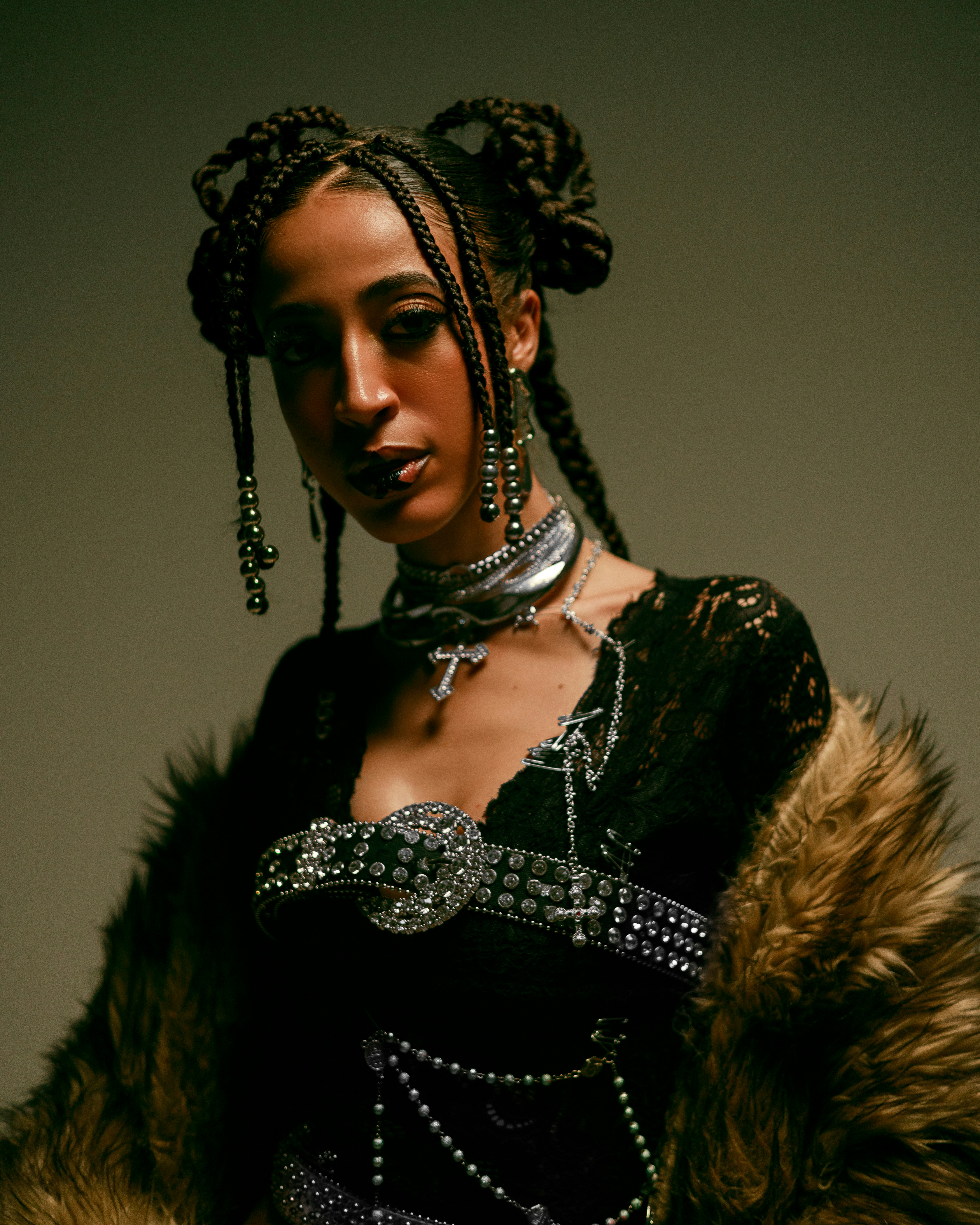 A woman poses in a bold, stylish outfit.