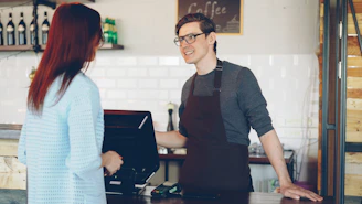 A barista takes an order from a customer
