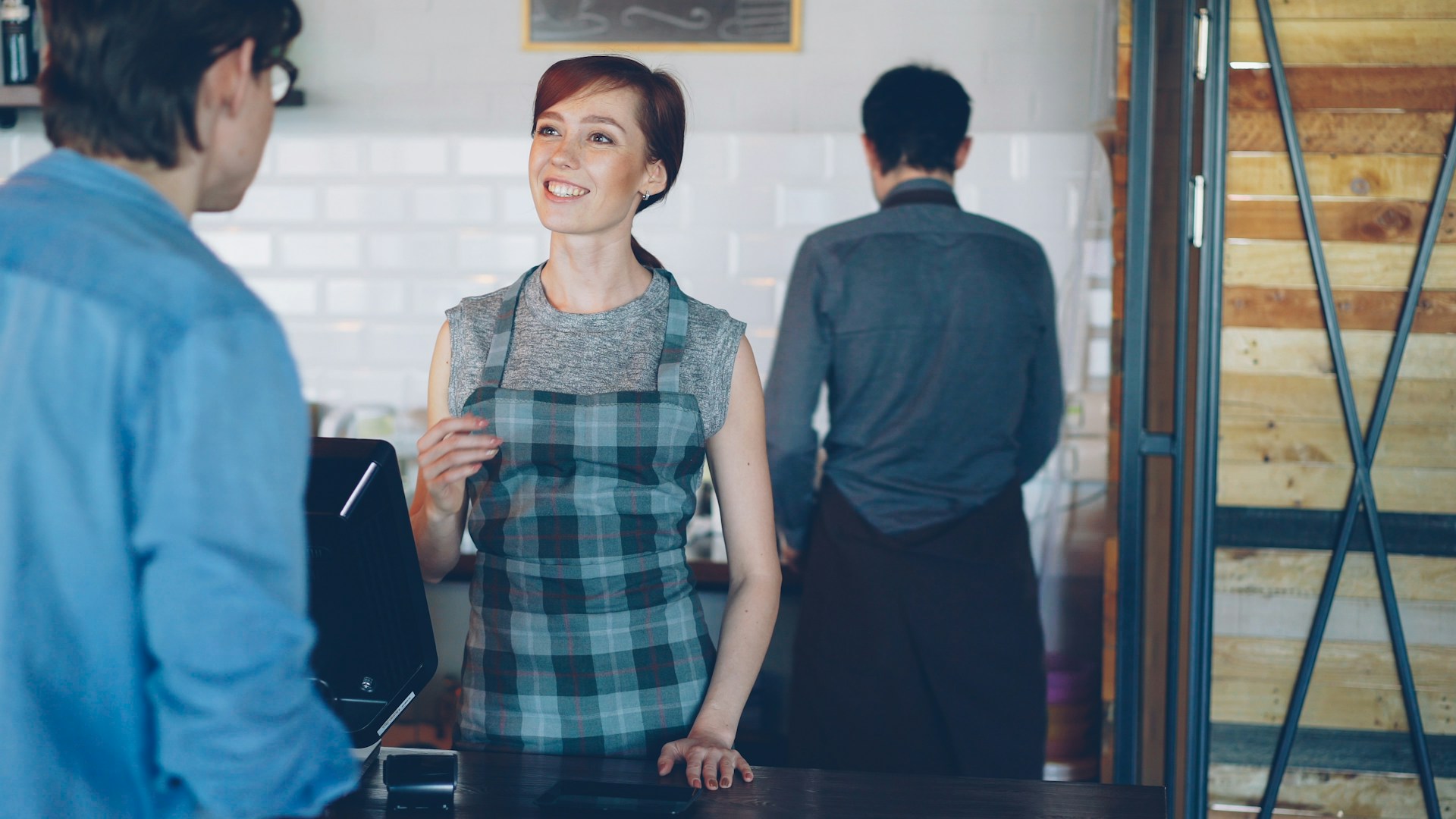 A barista is talking to a customer.