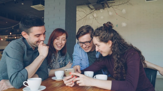 Friends share and enjoy a smartphone together.