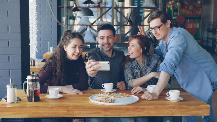 A small group of friends laughing together at a casual reunion