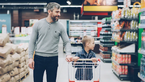 A father and son shop together in a supermarket.