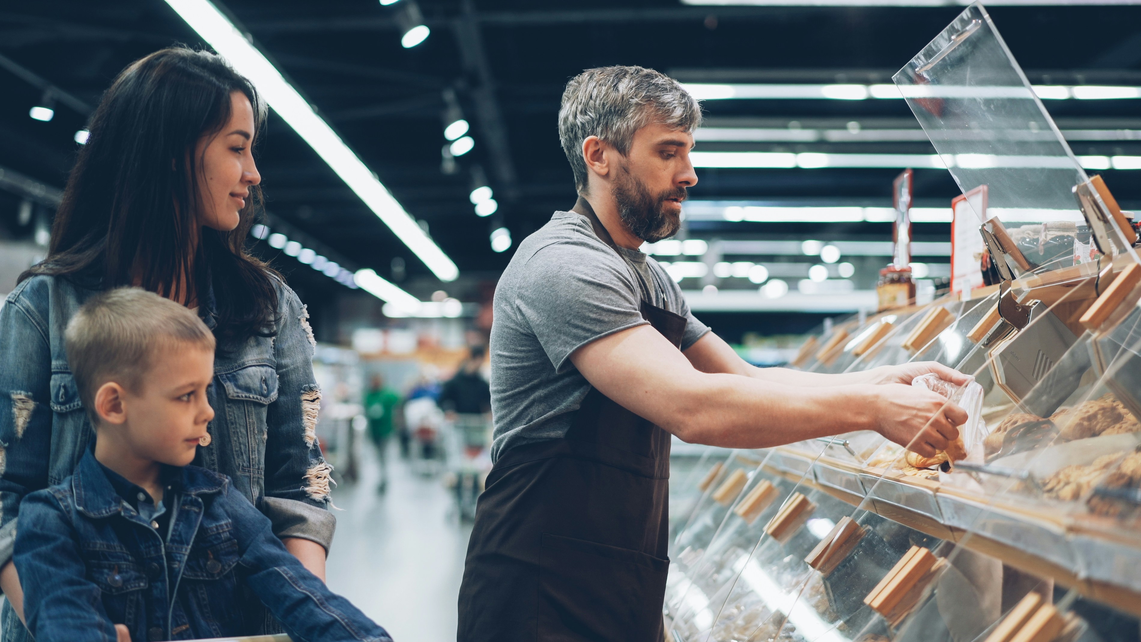 A family shops at a food display.