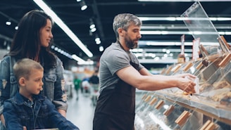 A family shops at a food display.
