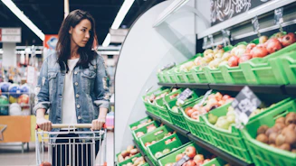Woman shops for produce at a supermarket
