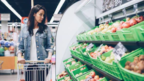 Woman shops for produce at a supermarket