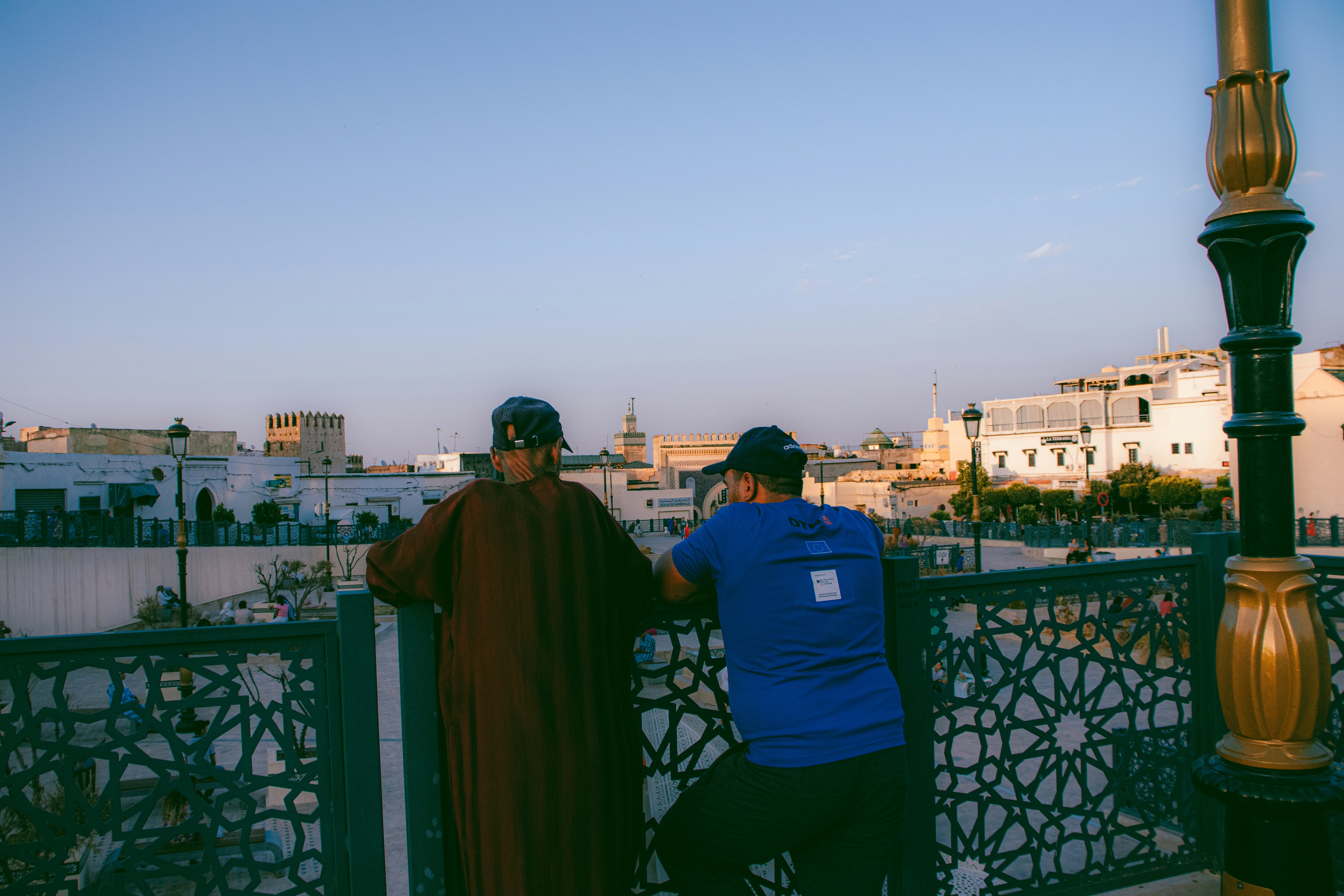 Two men admire a city view.