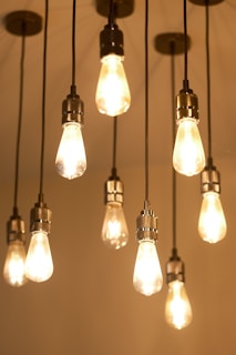 Several glowing edison-style light bulbs hang.