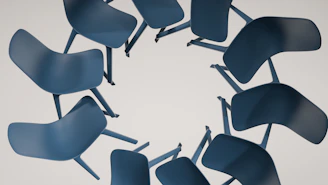Chairs are arranged in a circular shape.