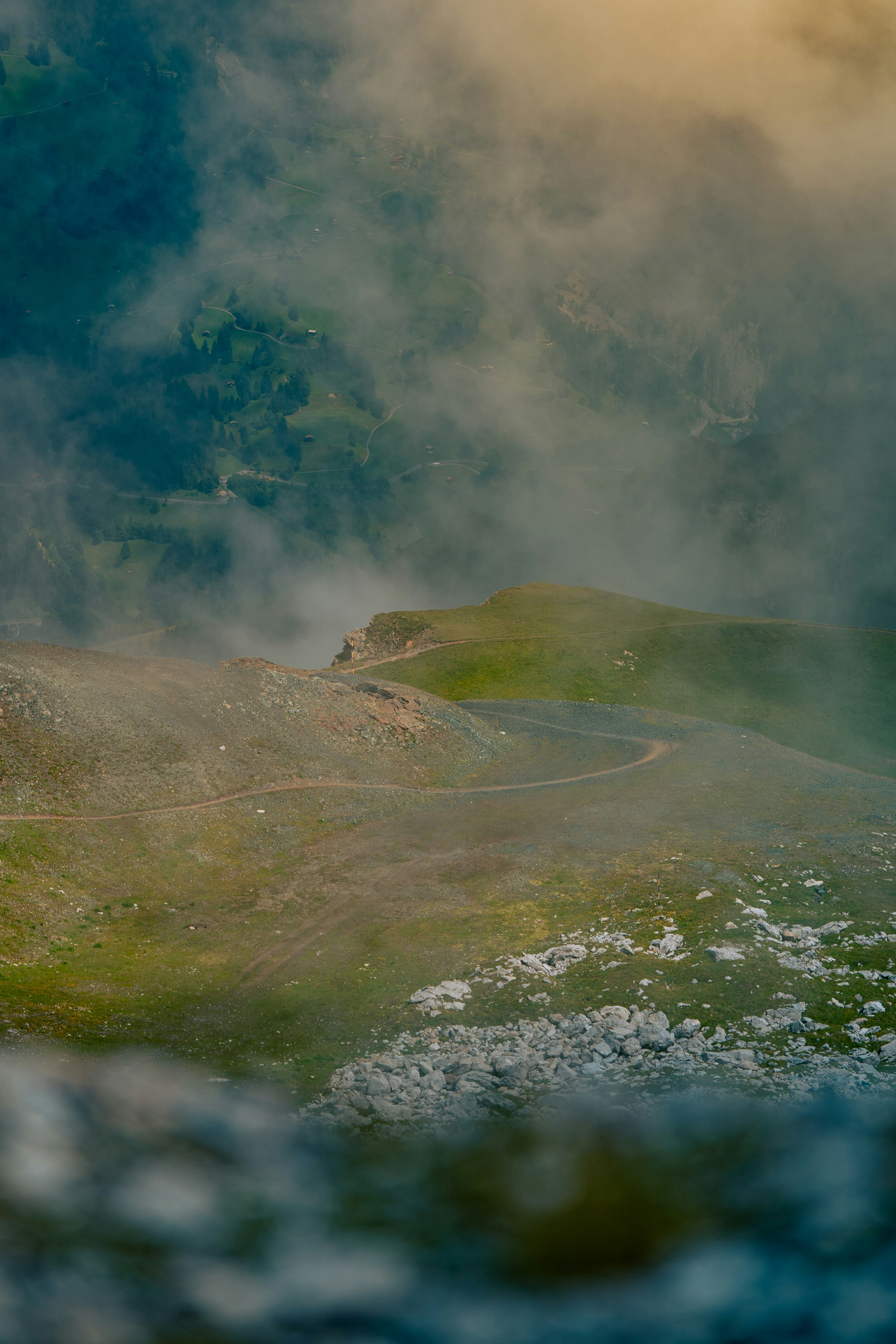 A winding road on a foggy mountain.