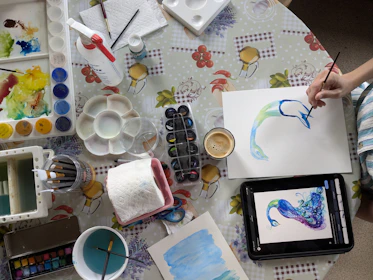 Someone is painting a watercolor picture of a dolphin.