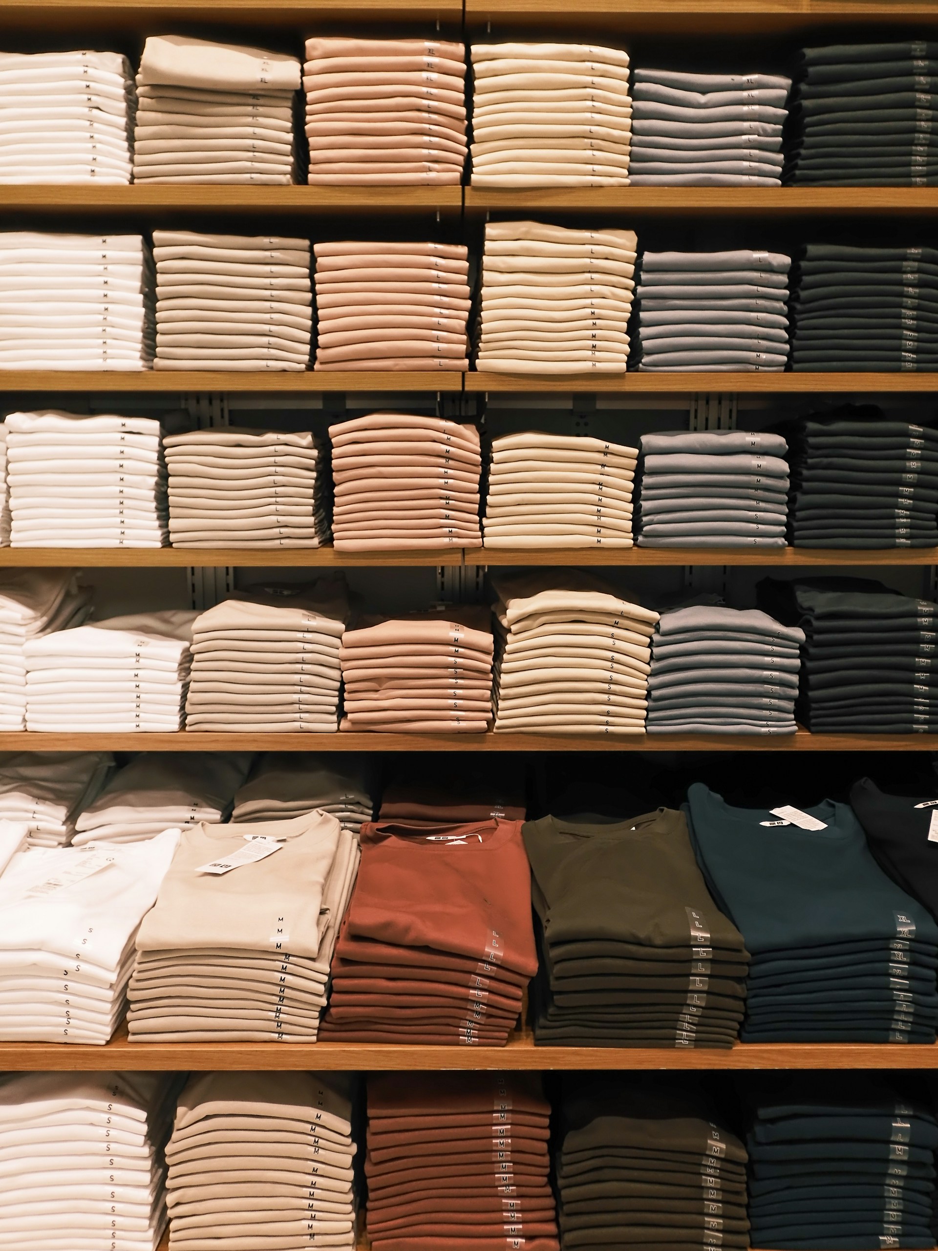 Neatly folded clothes displayed on shelves.