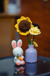 A crochet bunny and flowers.