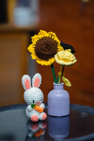A crochet bunny and flowers.