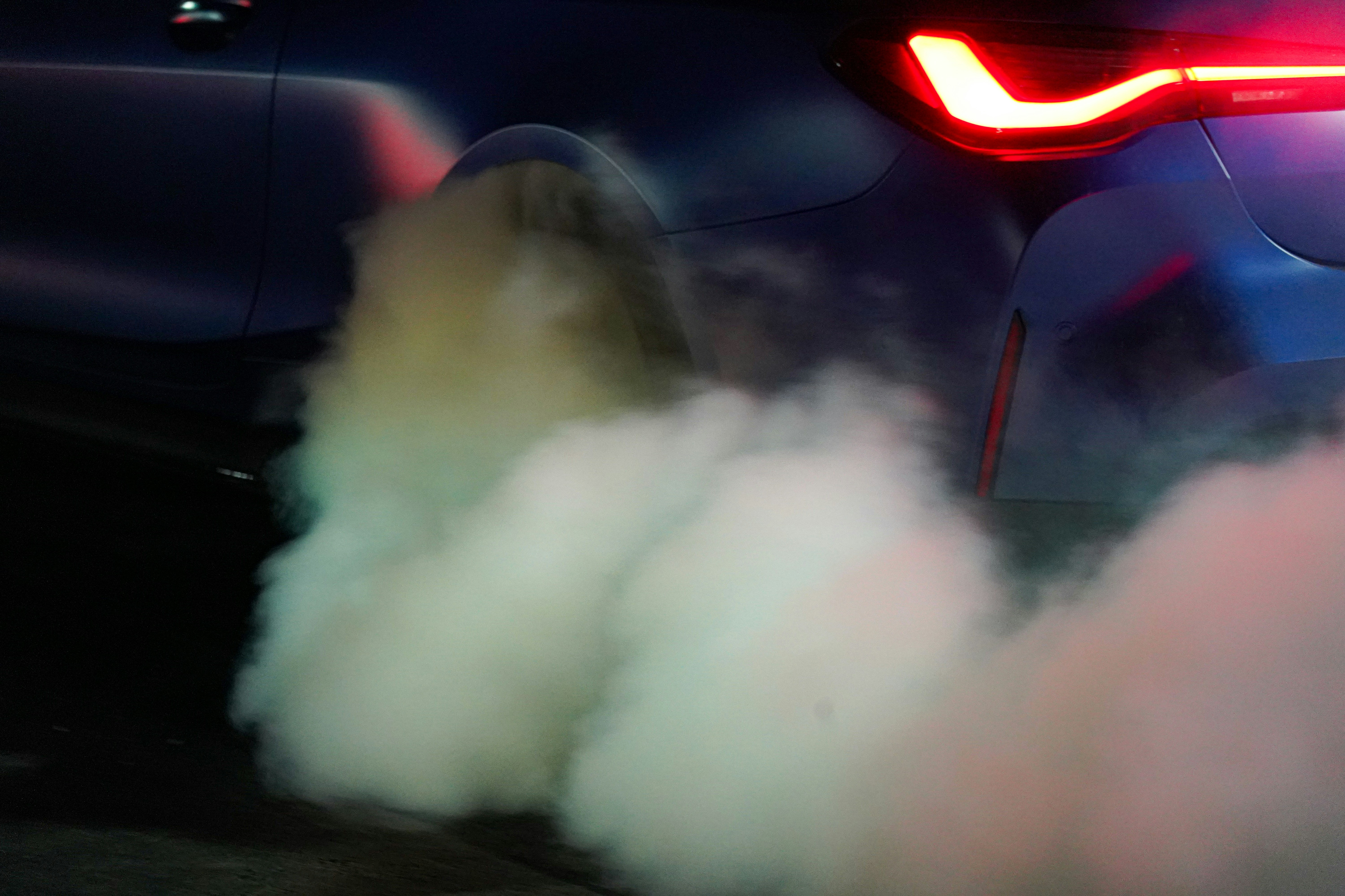 Car's tailpipe with visible smoke - exhaust diagnostic