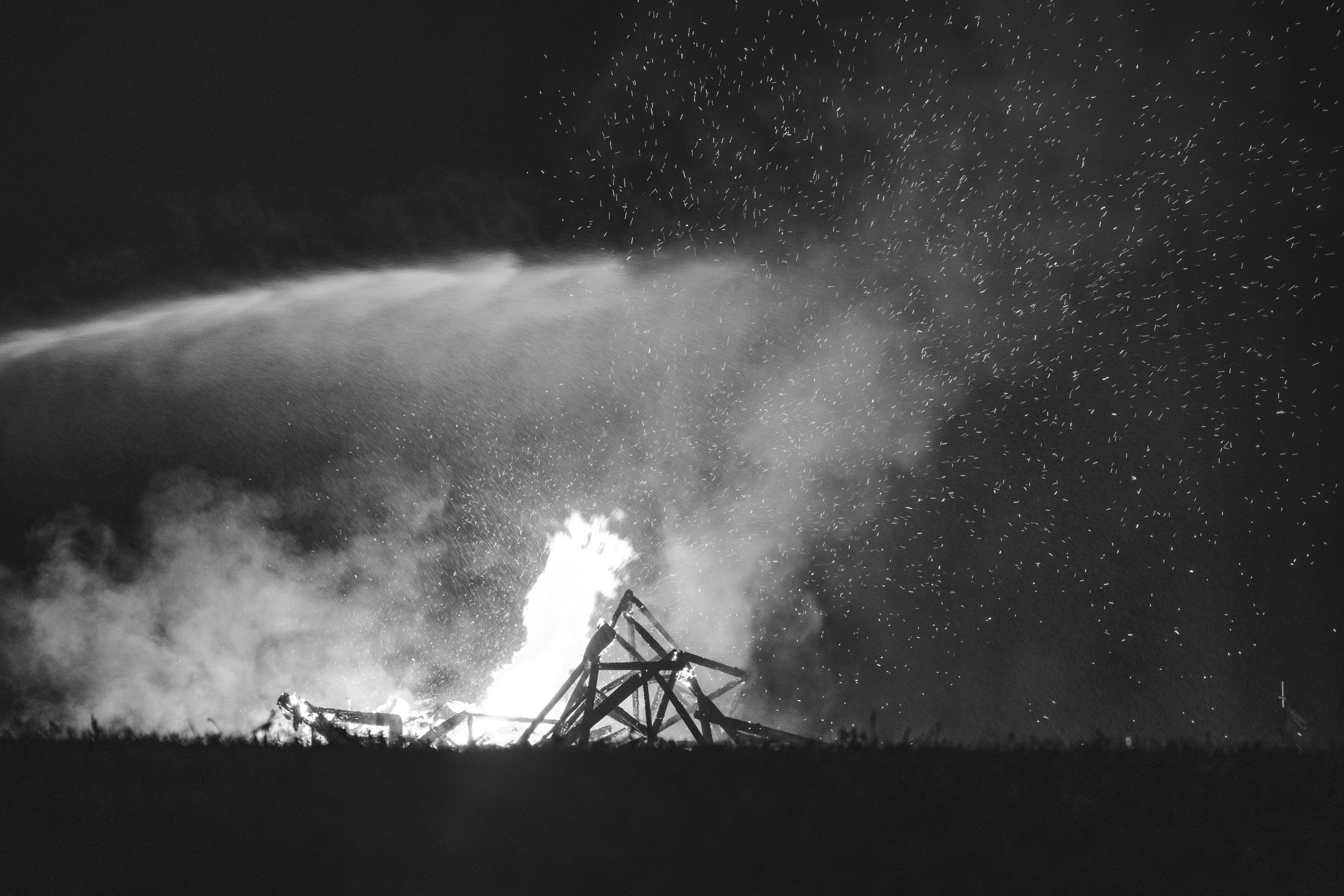 A fire is being extinguished with water.