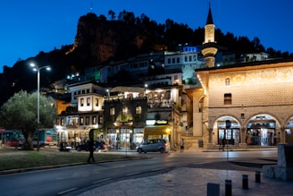 Nighttime view of a historic city with a mosque.