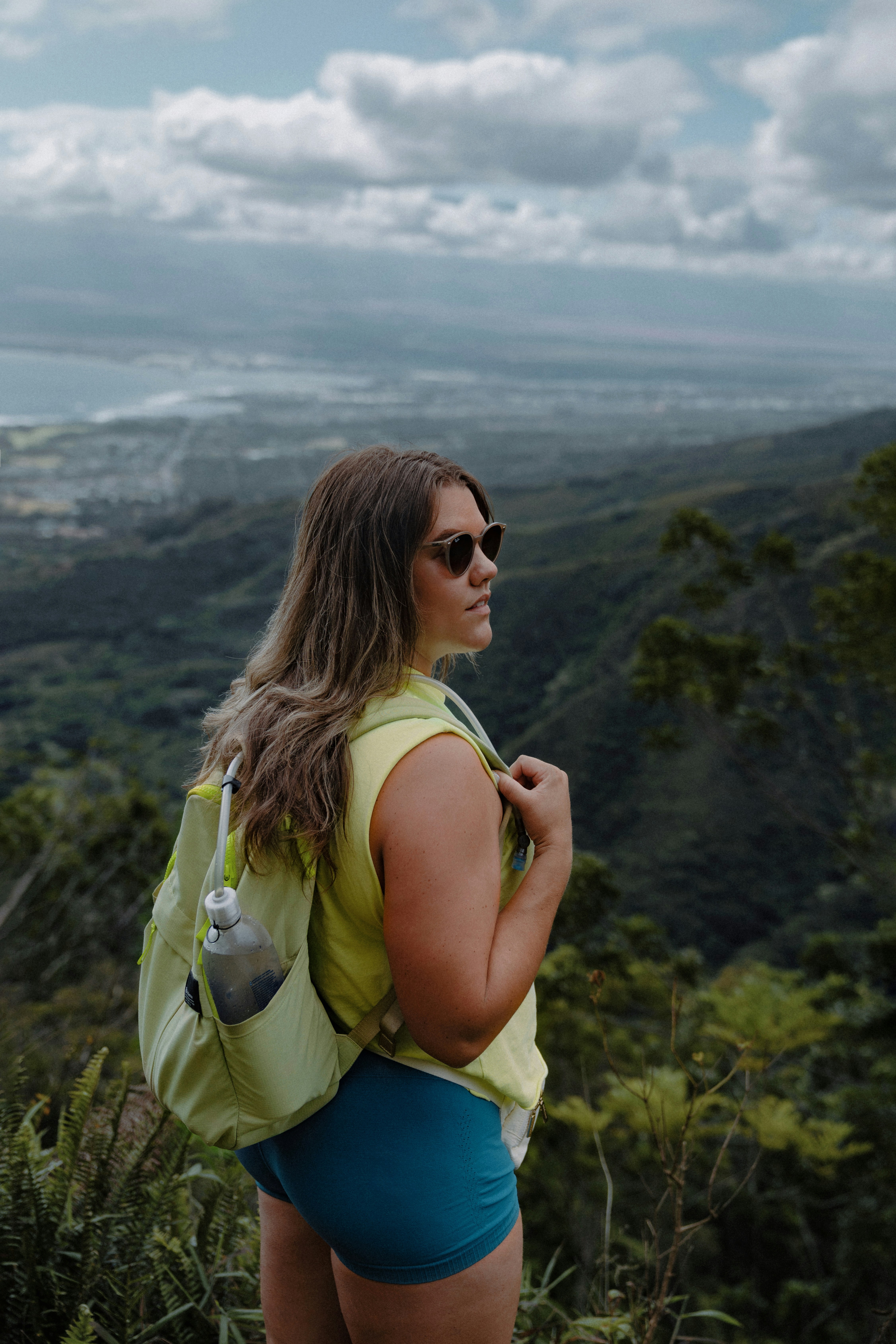 Woman enjoys a mountain view after hiking.