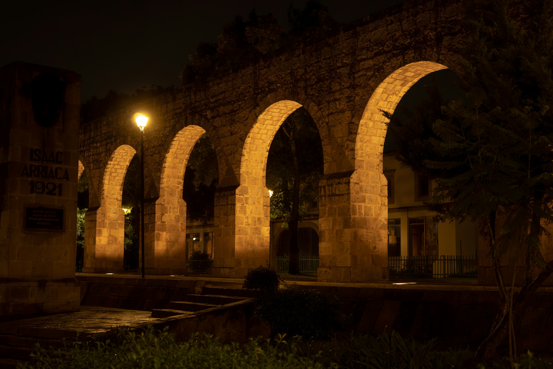 Illuminated arches glow at night.