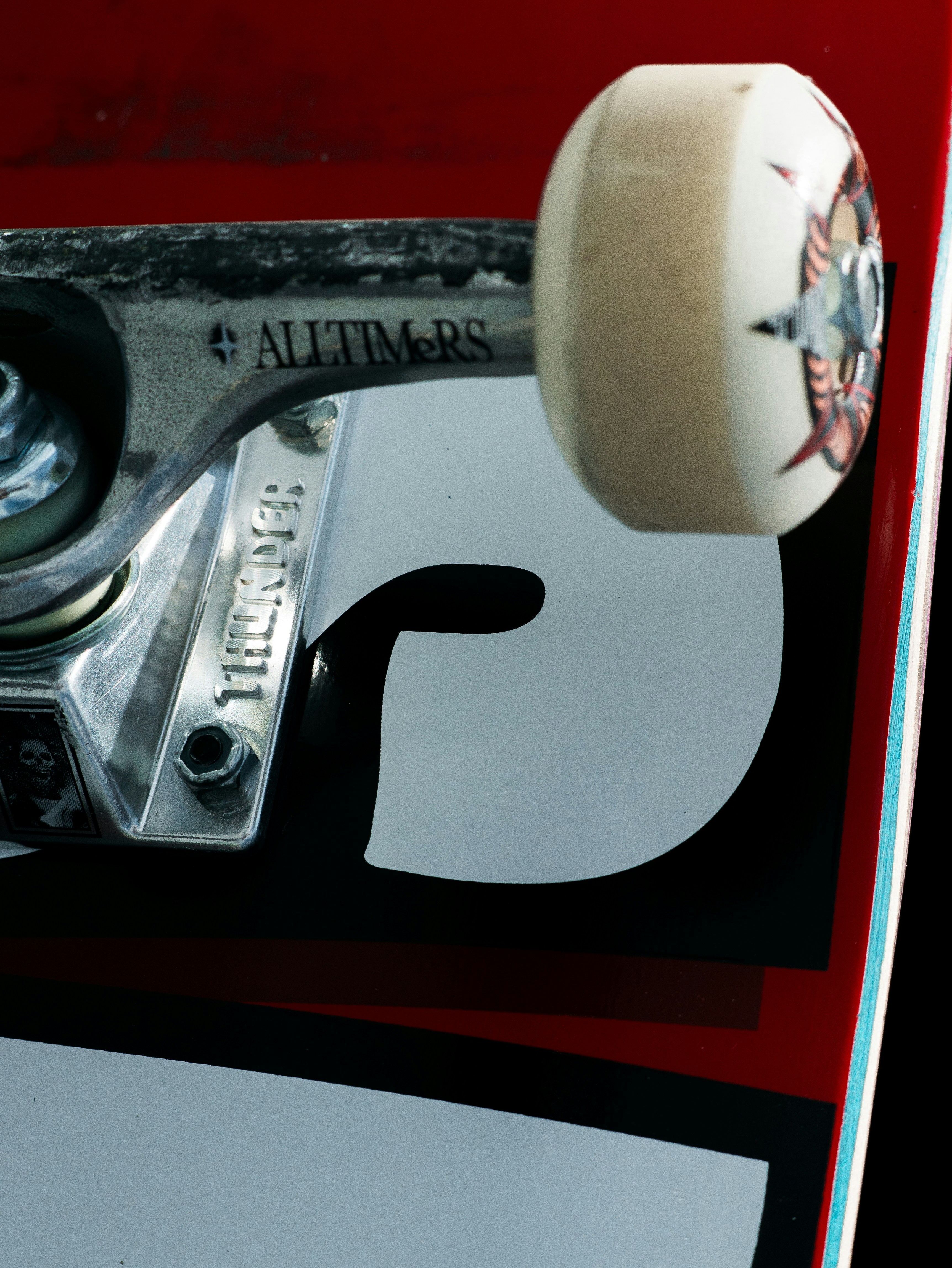 A close-up shows parts of a skateboard.