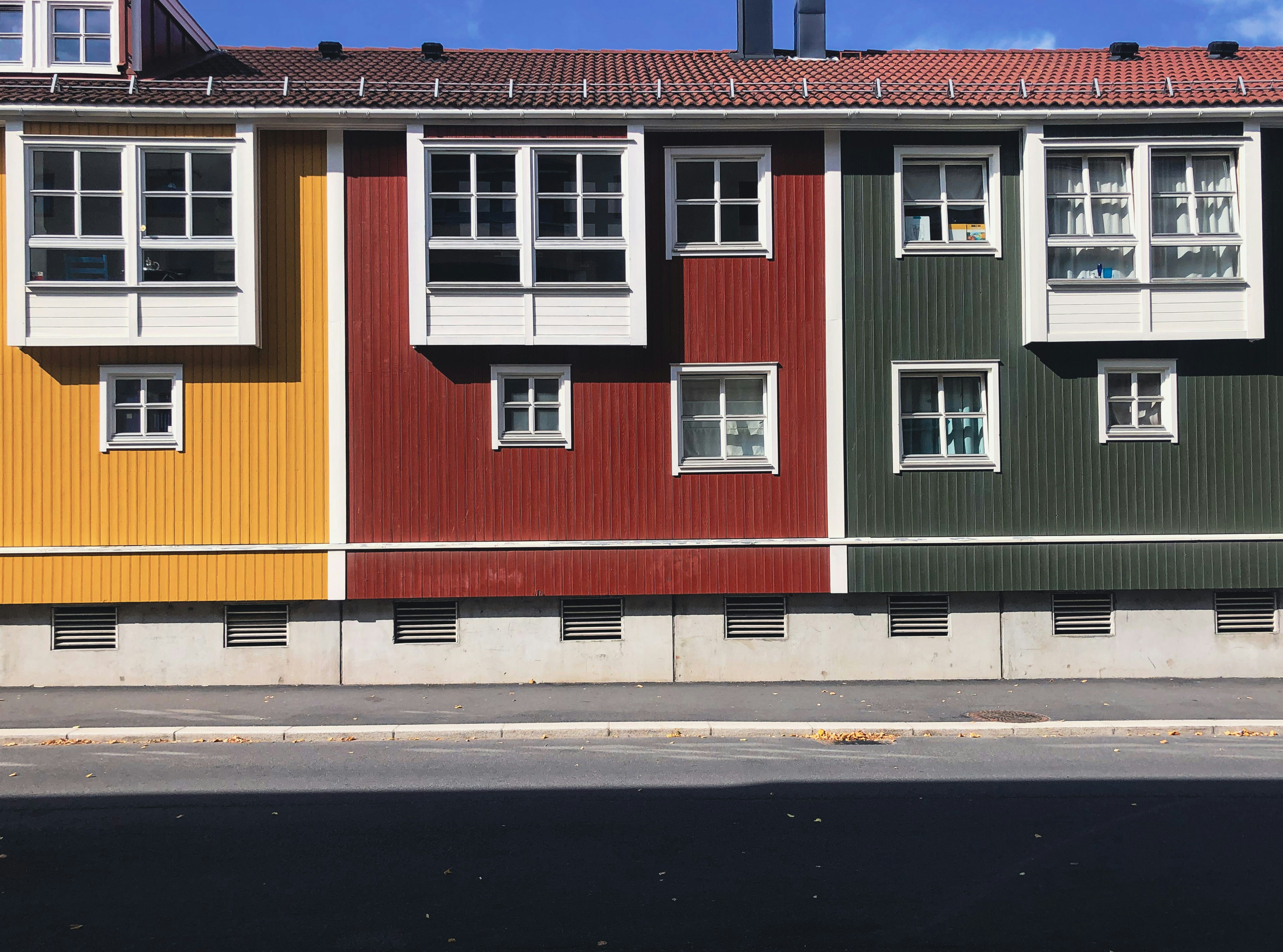 Colorful building facade with vibrant yellow, red, and green sections.